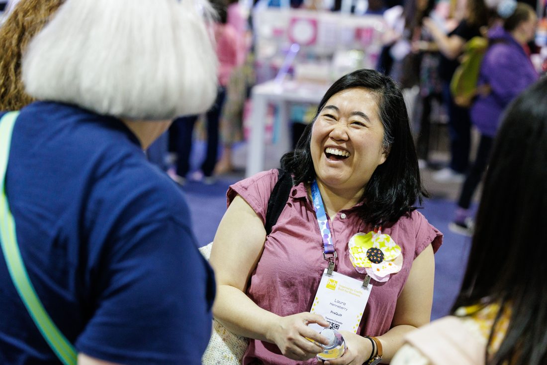 A shop owner in conversation on the show floor