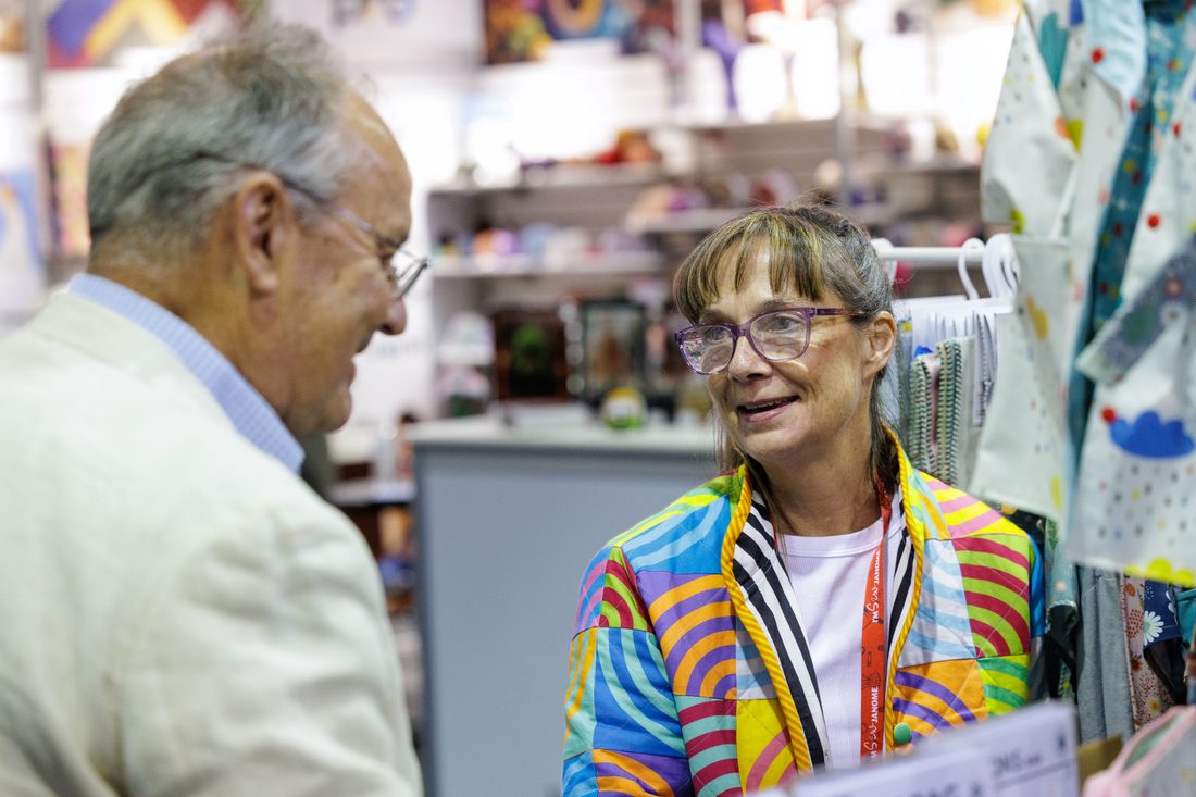 A buyer reviewing product with an exhibitor